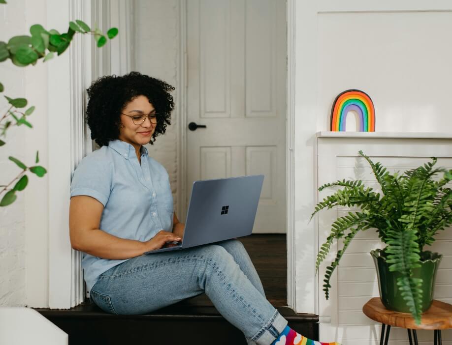 A woman on hero laptop for a telehealth call.